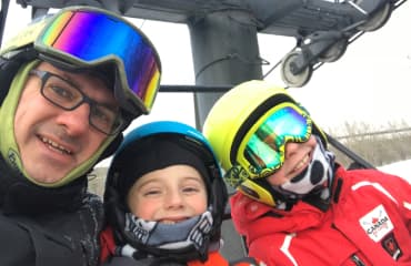 Kevin and his kids on a ski lift