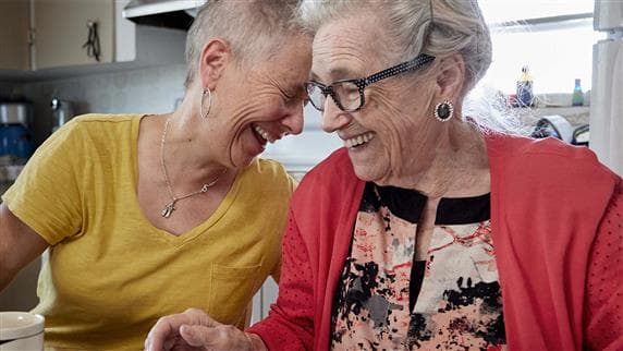 Two elderly people laughing