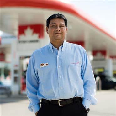 A Petro-Canada employee standing in front of his store.