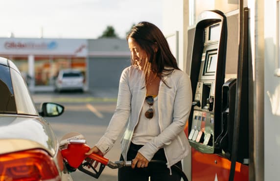 A woman filling her car at a Petro-Canada station.