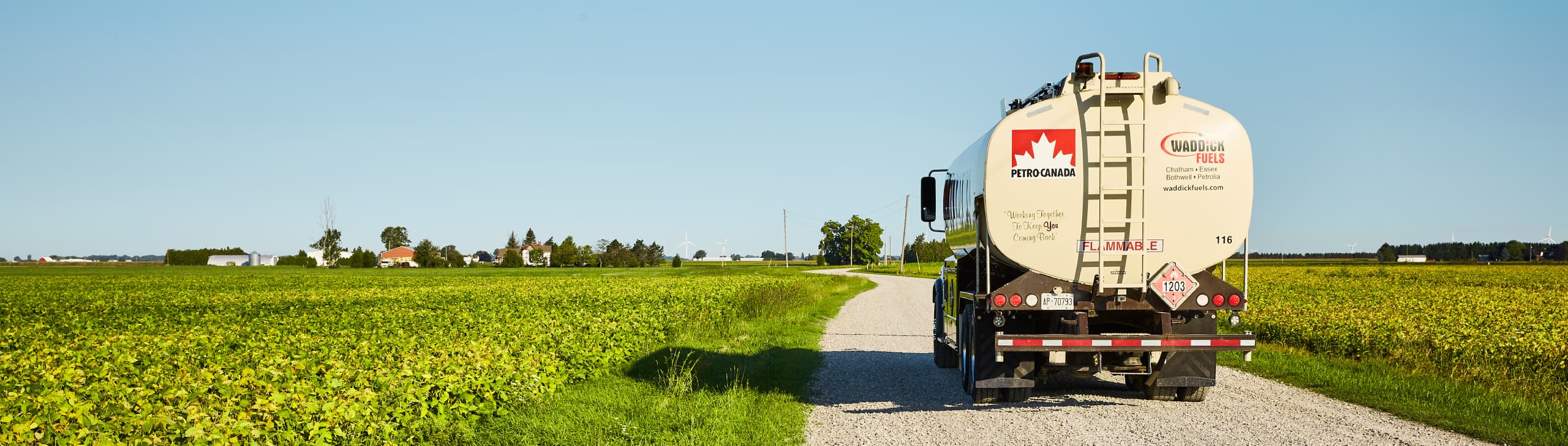 A truck driving through farmland